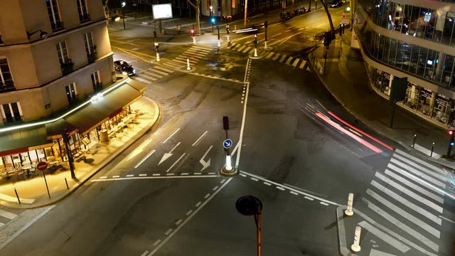 Paris Intersection Time-lapse. Fast moving traffic pass through a multi-way intersection in late night Paris, France.