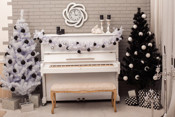 Black and White Christmas tree near white piano. Frontal