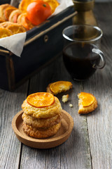 Homemade cookies with sliced tangerines and Christmas toys in a dark box. Selective focus.