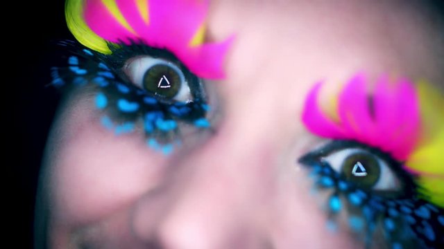 4k Colourful Woman Eyes Close-up with Feathers Eyelashes Flapping