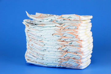stacking diapers isolated on blue background