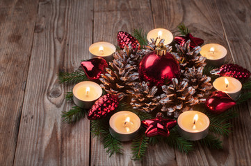 Christmas decoration with ball candle pine cones pine branch wooden table