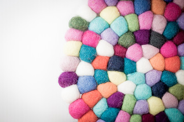 Colorful balls of wool. Handmade felt balls. Dried balls of wool. Potholder with colorful beads.Isolated on white background.