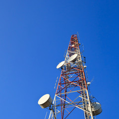 Telecommunications tower on blue sky.