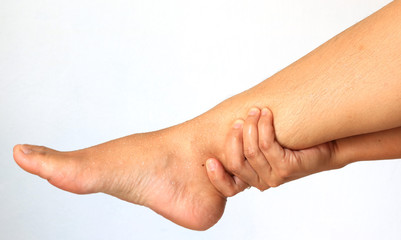 Woman hands leg massage for pain relief on a white background