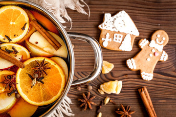 preparation of mulled wine in pot wooden background top view