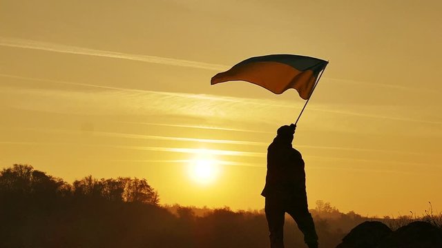 Soldier silhouette, Ukrainian Flag, sunrise time  in Slow Motion 
