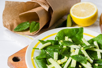 Salad of the cucumber and spinach with lemon and oil, healthy meal concept