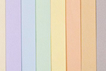 Background of pastel colors paper , parallel vertical stripes