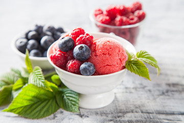 raspberry ice cream with berries, selective focus