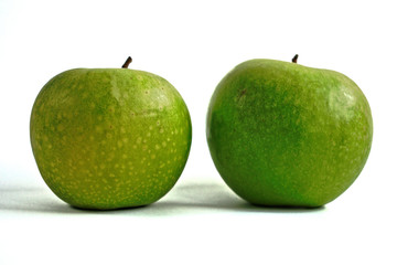 Two green apples on a white background