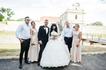 Stylish friends on wedding background bridge of castle. Groomsma