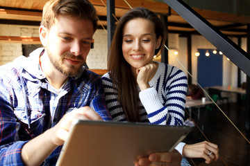 Team job. Photo young businessmans crew working with new startup project in modern loft. Generic design notebook on wood table.