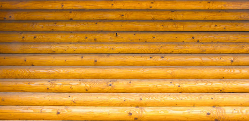 Wall log house with a beautiful texture treated