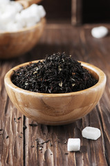 Raw tea and white sugar on the wooden table