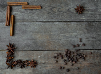 anise pepper and cinnamon sticks on wooden background