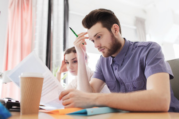 creative team with computer and papers in office