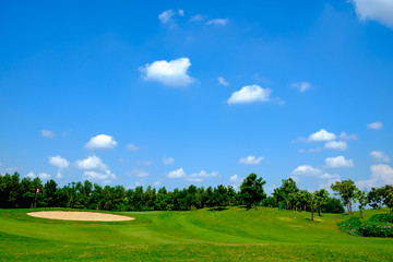 green golf field and blue cloud sky for backdrop background use - 127899347