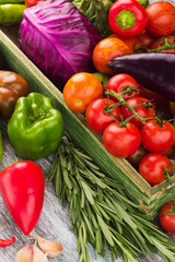 Set of raw vegetables in the wooden tray