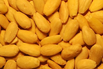 Pile of almonds close-up as background.