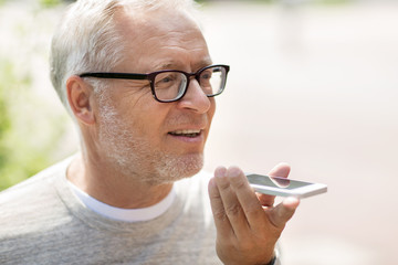 old man using voice command recorder on smartphone