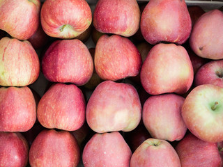Background of red apples close up. Red apples pattern on sale at the market.