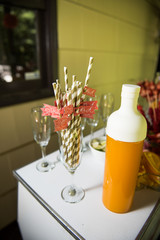 Yellow bottle stands on the candy bar