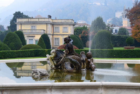 A view of the picturesque fountain with Baroque sculpters in сity Como