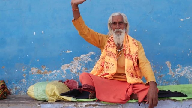 Sadhu baba, Indian holy man, giving blessings with his right hand raised in Pushkar, Rajasthan