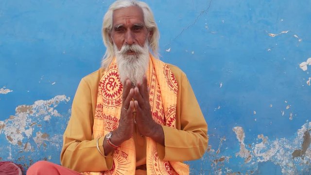Hindu Sadhu, holy man, smiling and hands in namaste prayer mudra