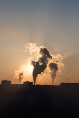 Urban smoke of factory. City sunrise.