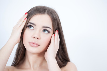 Fototapeta premium Beautiful Young Woman with Fresh Clean Skin touch own face. Cosmetology, beauty and spa. 