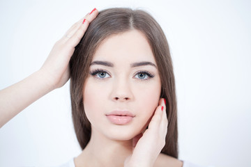 Obraz premium Beautiful Young Woman with Fresh Clean Skin touch own face. Cosmetology, beauty and spa. 