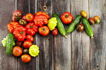 Fototapeta na wymiar vegetables (tomatoes, cucumber) on wooden background