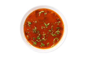Traditional Romanian vegetables soup chorba with tomatoes sauce (Ciorba de legume), isolated on white background