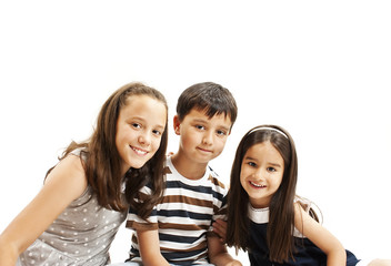 Beautiful portrait of two sisters and a brother. Isolated on white background