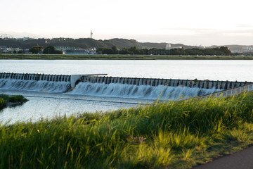 Fototapeta na wymiar The Weir in Tamagawa, Tama river in Japan from the river bed