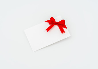 Card with red ribbons bows .