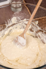 Mixing dough with wooden spatula