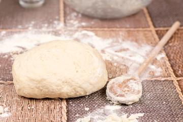 Prepared pizza dough on the table
