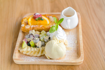 French toast with powdered sugar and a strawberry on wood table