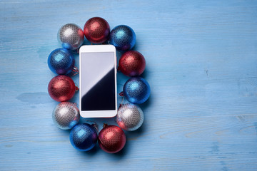 The wooden table with a phone and Christmas decorations.