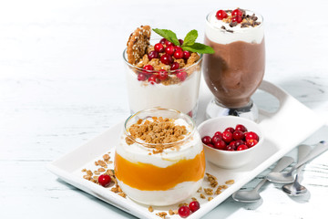 desserts with pumpkin, chocolate and biscuits on white tray