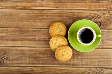 green cup with coffee and cookie
