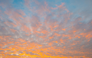 Clouds in a blue sky in autumn at sunrise
