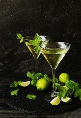 Martini or mint liqueur with lime, selective focus