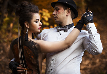 Couple in tango pose imitating music performance on viola painted on woman's back © Yevgeniy Zateychuk