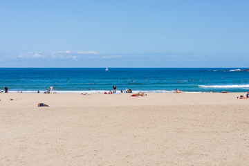 Surfer do water sport, people relax at the beach La Zurriola in Donostia San Sebastian. The beach is situated at the district Gros of San Sebastian. The beach is famous for surfing,sports and relaxing