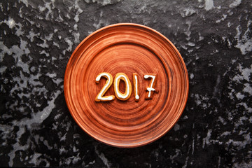 Christmas cookies and inscription in 2017 on a plate and glass t