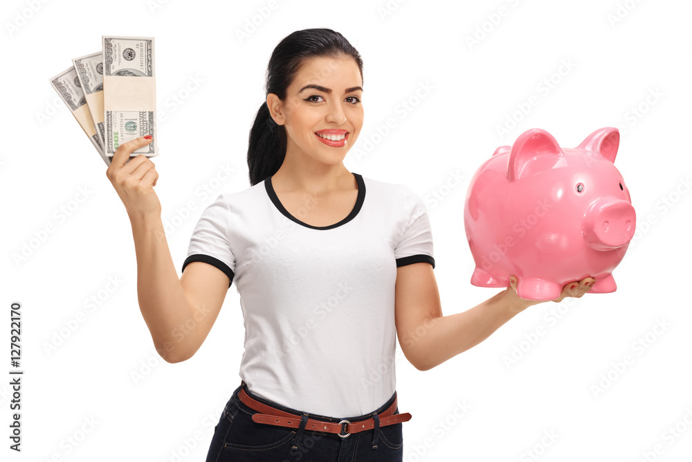 Canvas Prints young woman holding bundles of money and piggybank